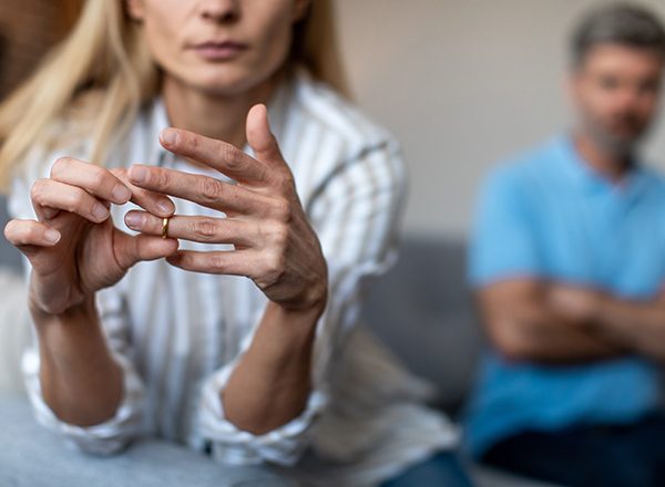 A couple in bed, turned away from each other